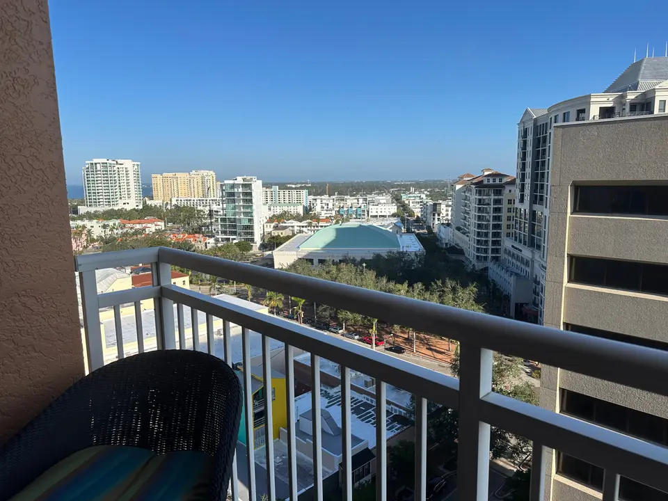 High-floor balcony view over downtown Sarasota toward the bay and barrier islands