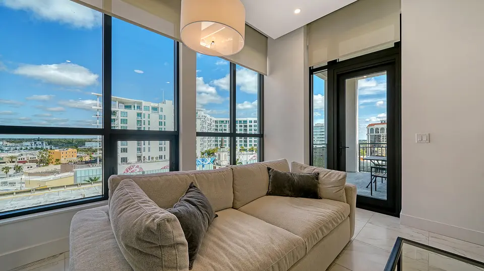 Living room with floor-to-ceiling windows overlooking downtown Sarasota