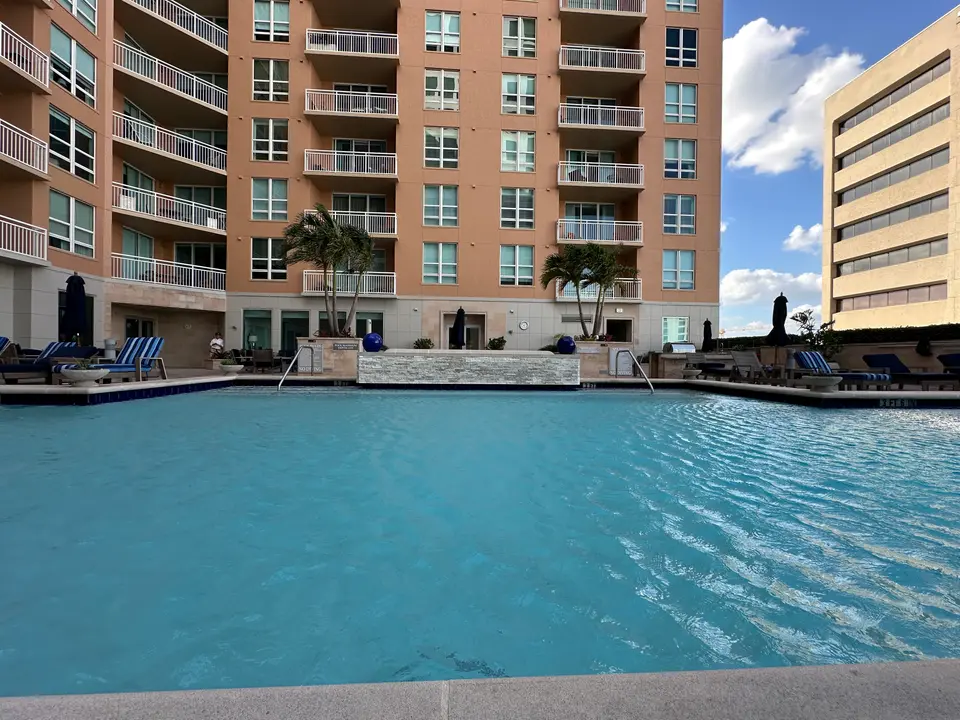 Resort-style pool deck surrounded by a downtown Sarasota condominium tower