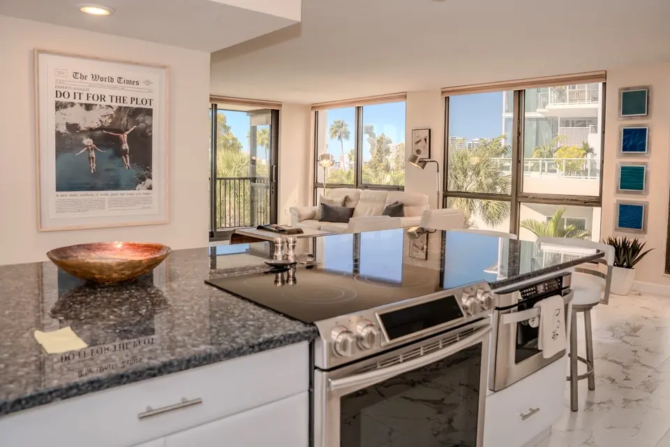 Corner condo kitchen and living area with bay views