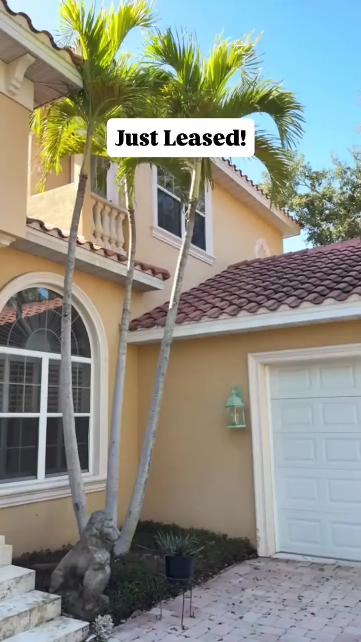 Two-story home with a red tile roof and a Just Leased label