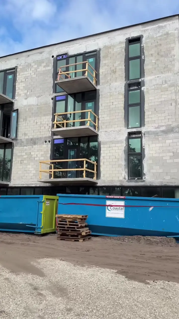 New condo building under construction with balconies framed in