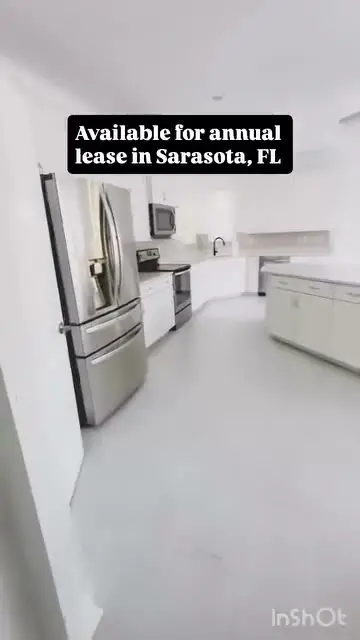 White kitchen with stainless refrigerator and an Available for annual lease label