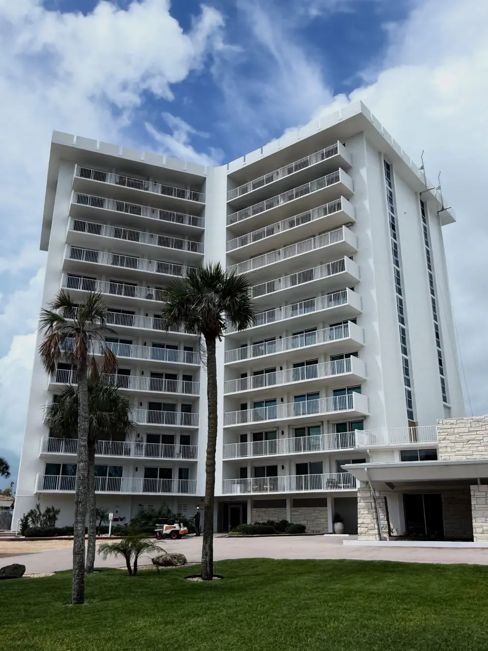 Gulf-front condo tower with palms on Longboat Key