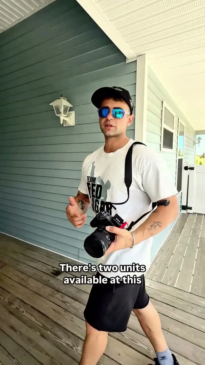 Richard with a camera on a dock walkway at a bayfront home