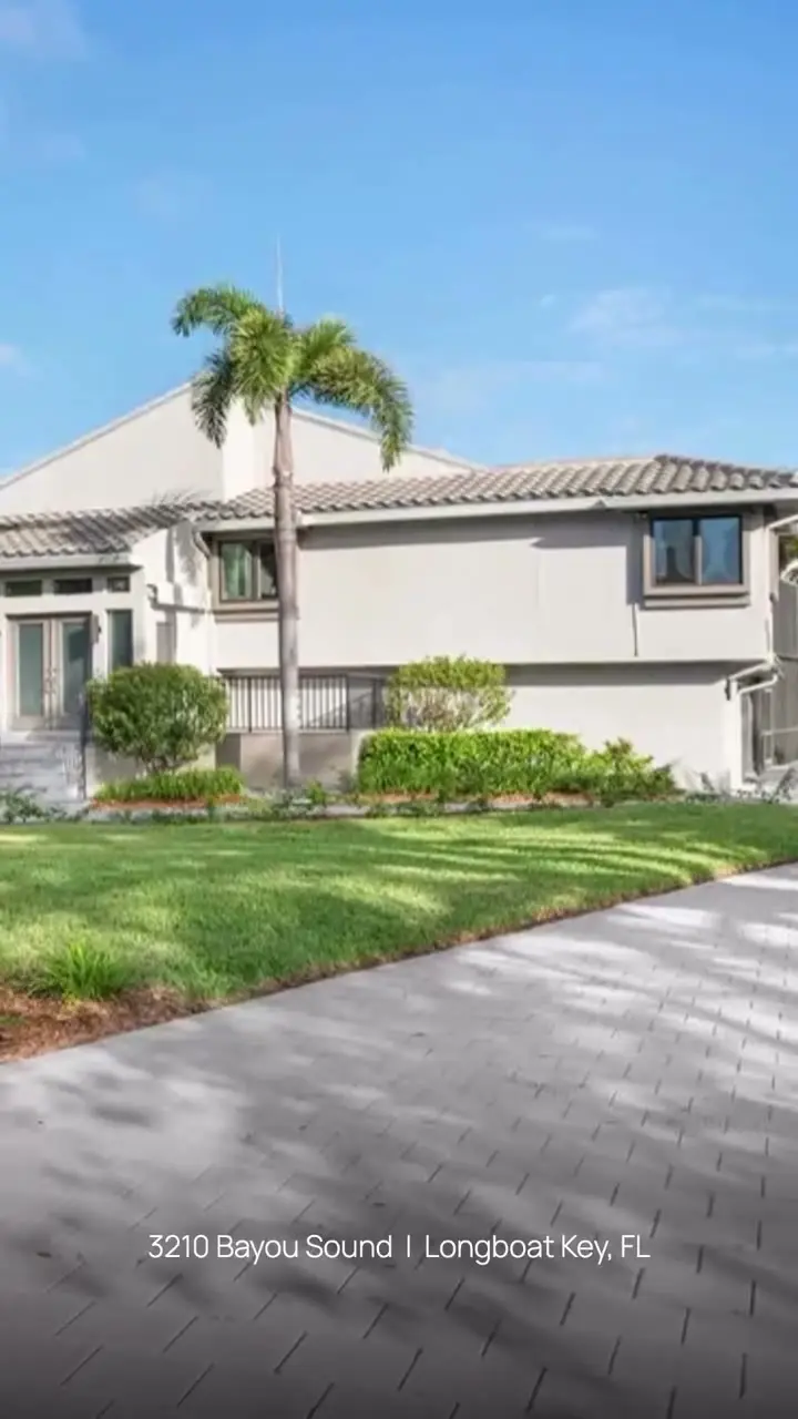 Light gray two-story home with palms on Longboat Key