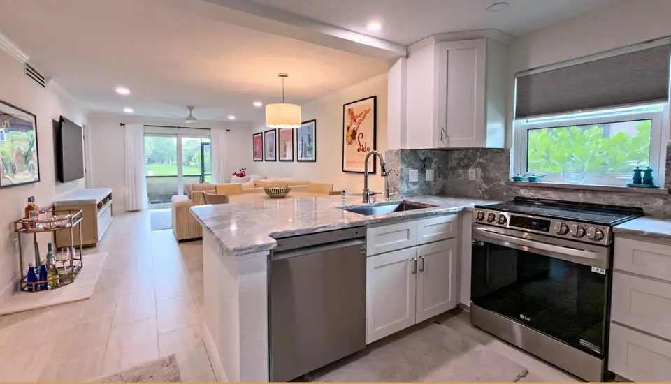 Open kitchen with stone counters and a breakfast bar