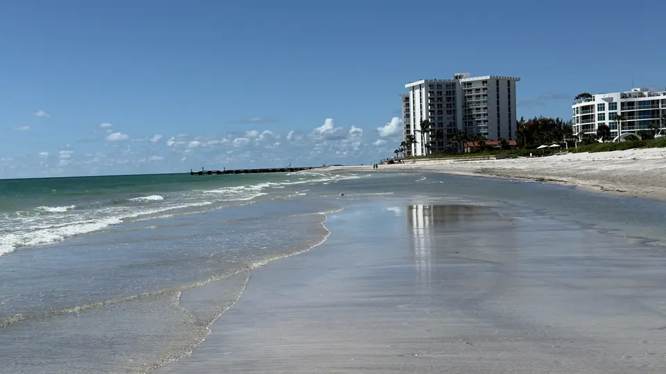 Calm Gulf shoreline on Lido Key with condominiums along the beach