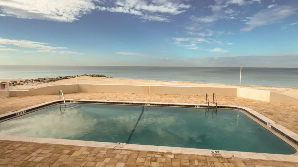 Beachfront pool with the Gulf of Mexico just beyond the deck