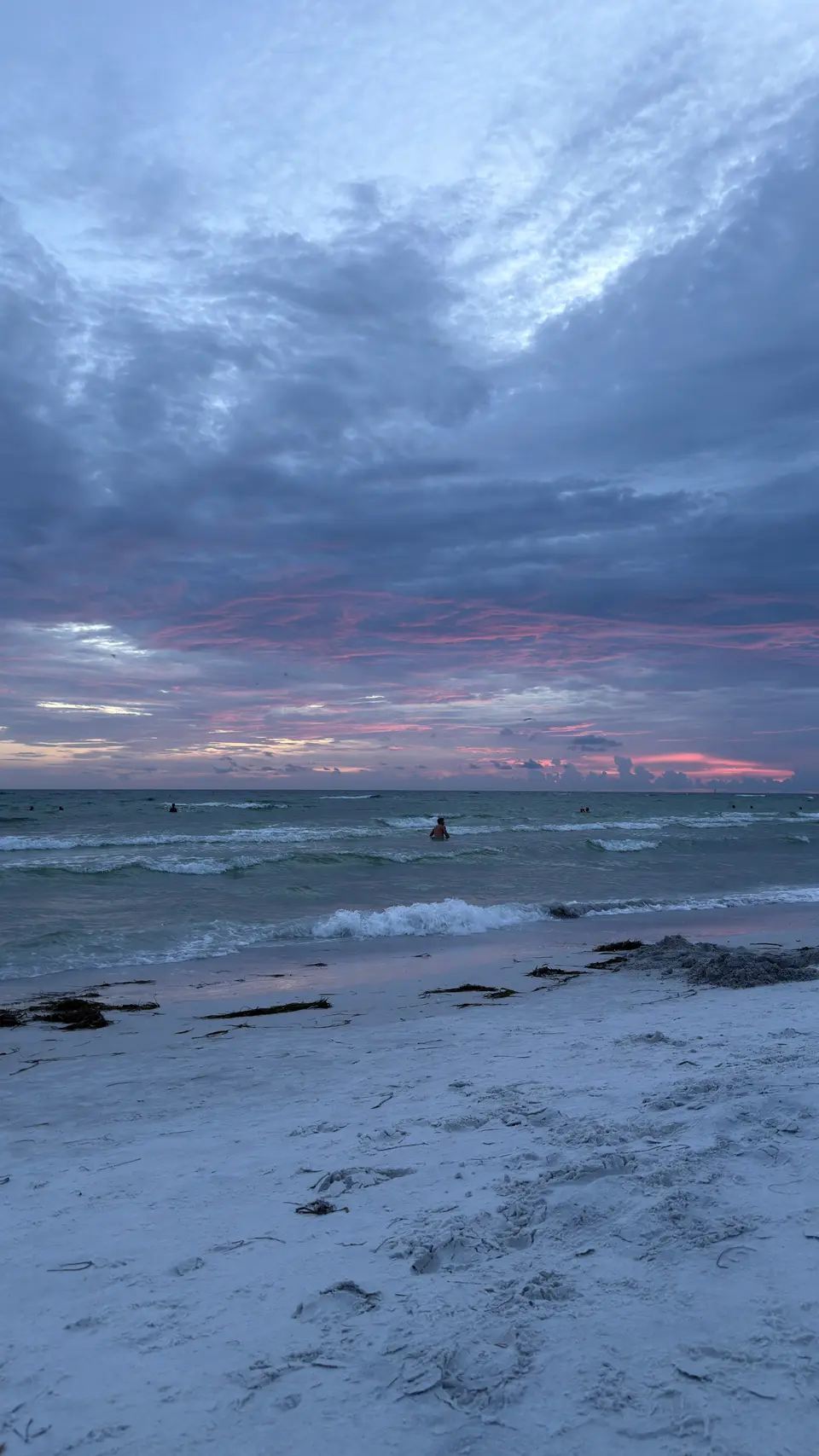 Streaks of pink cloud over the Gulf and white sand on Lido Key