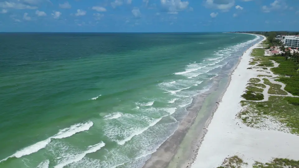 Aerial of white Gulf beach, dunes and turquoise surf on Longboat Key