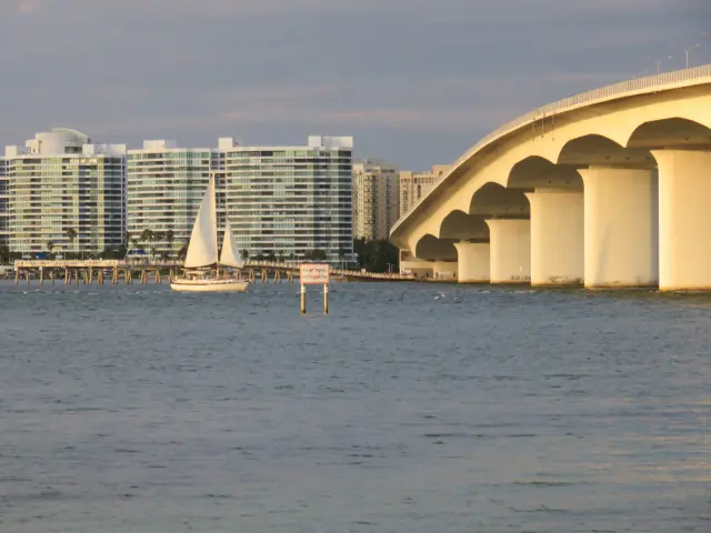 Sailboat on Sarasota Bay below the Ringling Bridge and downtown condo towers