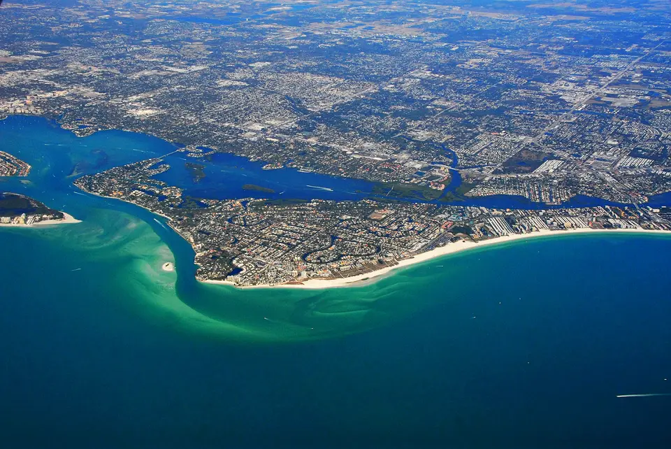 Aerial view of Siesta Key with white sand beach, Gulf water and the bay behind